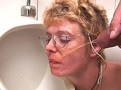 Horny golden-haired aged slut engulfing dick on the WC